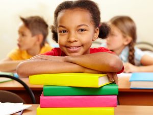 Second Grader Leaning on Books